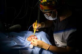 A surgeon performing a lip augmentation