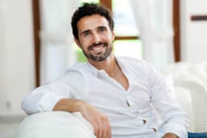 Handsome man sitting on his sofa